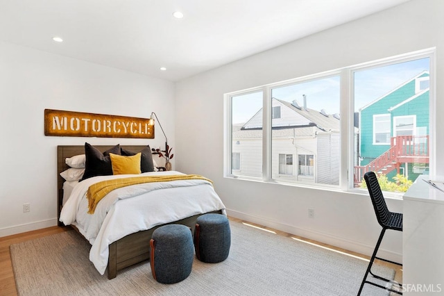 bedroom with hardwood / wood-style flooring