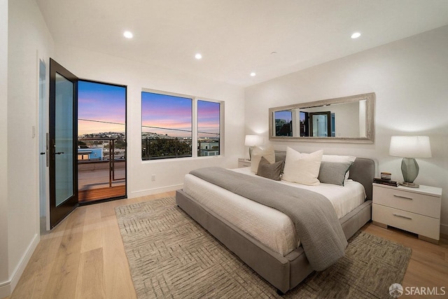 bedroom featuring light wood-type flooring and access to exterior