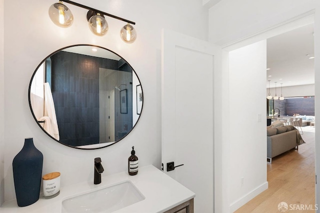 bathroom featuring a shower, vanity, and hardwood / wood-style flooring