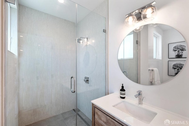 bathroom with vanity and a shower with shower door