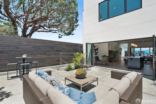 view of patio / terrace featuring an outdoor hangout area and sink