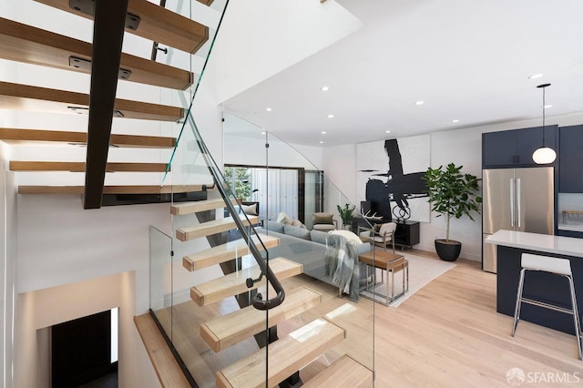 stairway with hardwood / wood-style floors