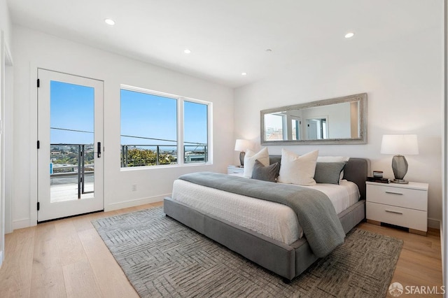 bedroom featuring access to outside and light hardwood / wood-style floors