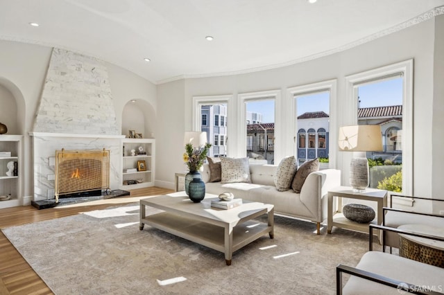 living room featuring a premium fireplace and light wood-type flooring