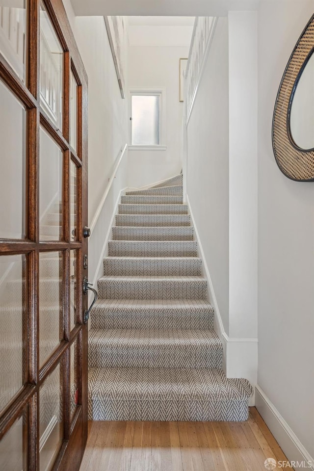 stairs with hardwood / wood-style flooring