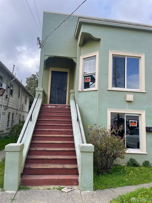 property entrance featuring stucco siding