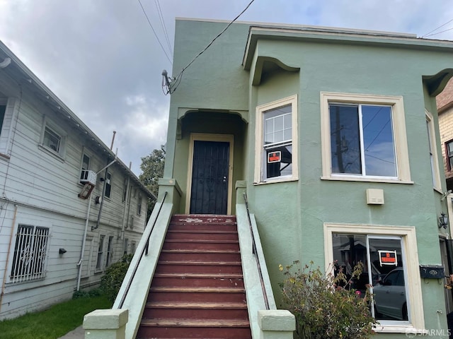 view of exterior entry with stucco siding