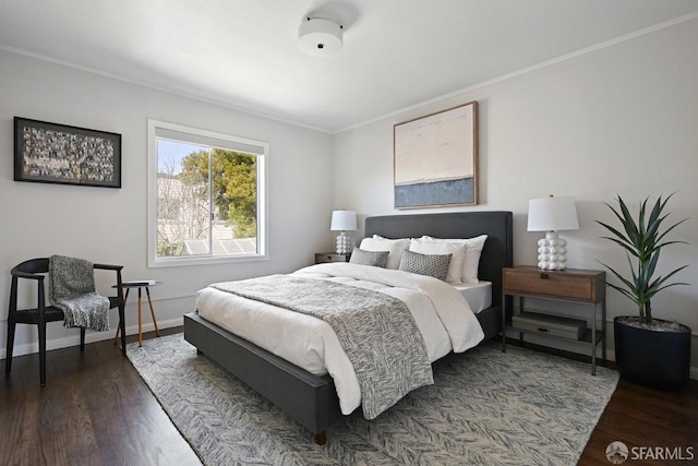 bedroom featuring crown molding, baseboards, and dark wood-style flooring