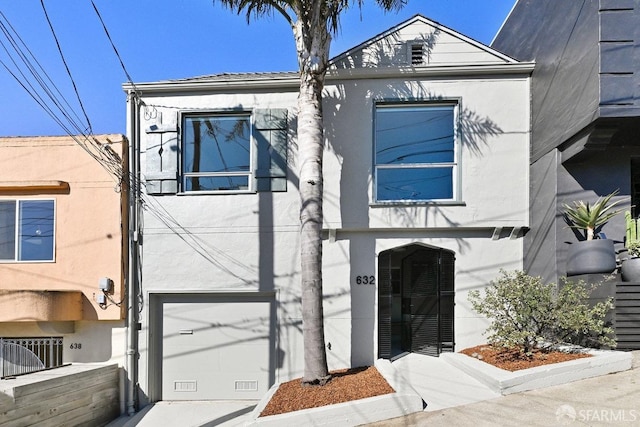 view of front of property with a garage and stucco siding