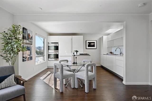 dining space with baseboards, dark wood-style flooring, and crown molding