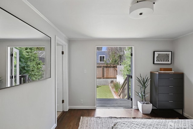 entryway with crown molding, baseboards, and wood finished floors