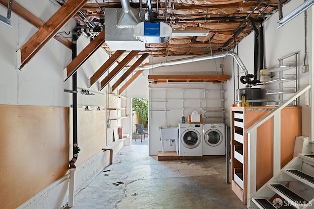 below grade area with washing machine and clothes dryer, gas water heater, and a garage