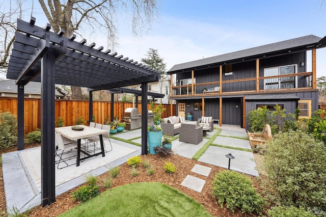 back of house with outdoor lounge area, a patio area, a pergola, and a balcony