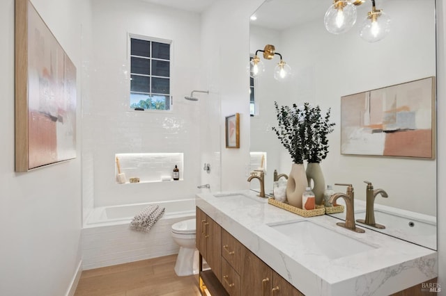 bathroom with wood-type flooring, toilet, and vanity