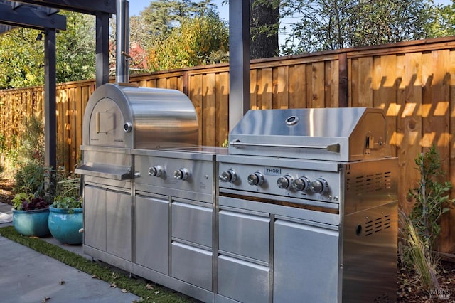 view of patio with an outdoor kitchen and area for grilling