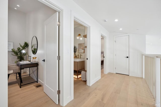 hall with light hardwood / wood-style floors and vaulted ceiling