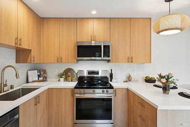 kitchen featuring sink, light brown cabinetry, hanging light fixtures, and appliances with stainless steel finishes