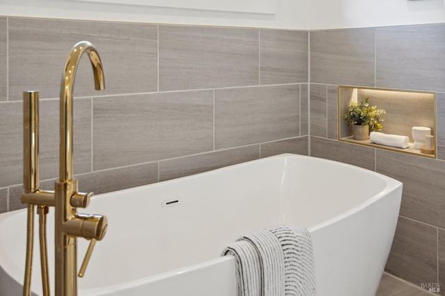 bathroom with a tub to relax in