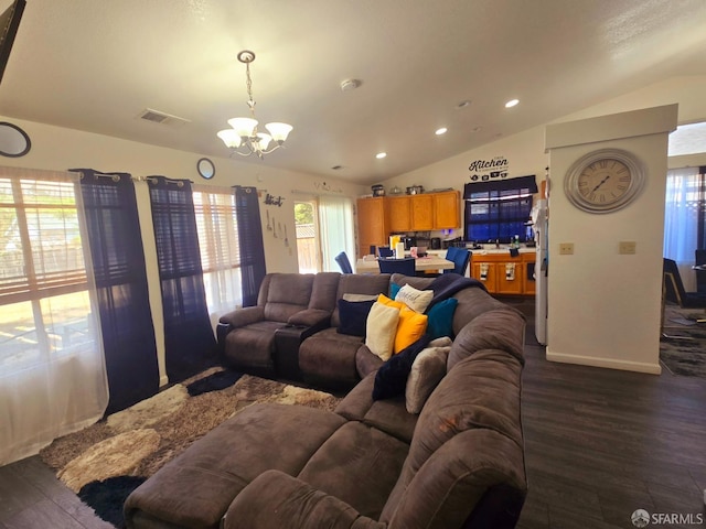 living room featuring lofted ceiling, dark wood-type flooring, and a chandelier