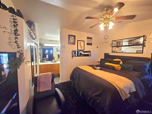 bedroom featuring ensuite bath, ceiling fan, and sink