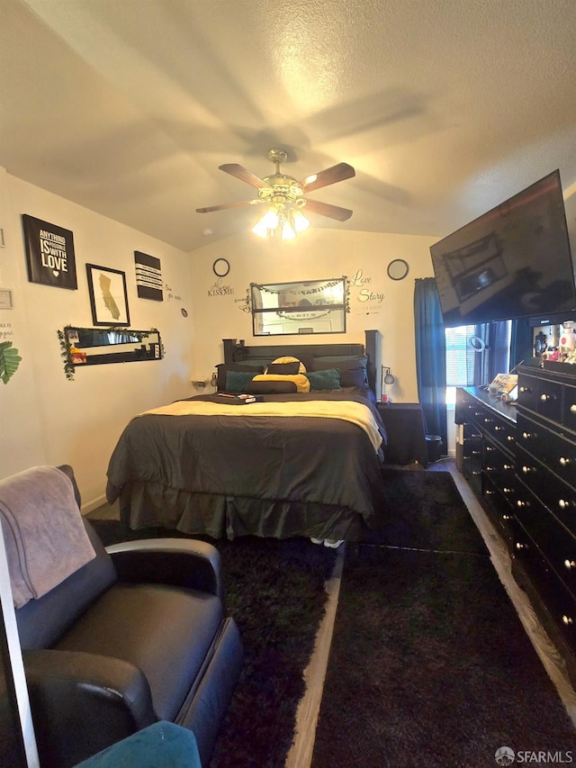 bedroom with ceiling fan, a textured ceiling, and vaulted ceiling