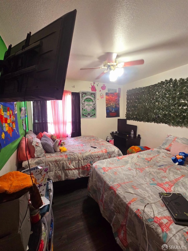 bedroom featuring ceiling fan, a textured ceiling, and dark hardwood / wood-style flooring