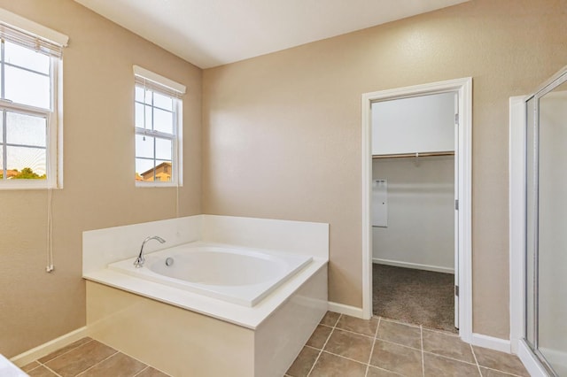 9877 Bluefin Way, Elk Grove, CA 95757 - bathroom with a stall shower, a bath, tile patterned flooring, and a spacious closet