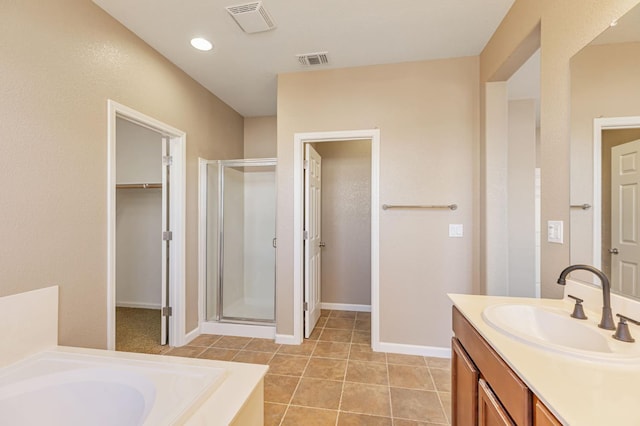 9877 Bluefin Way, Elk Grove, CA 95757 - bathroom with a stall shower, vanity, a bath, a spacious closet, and tile patterned flooring