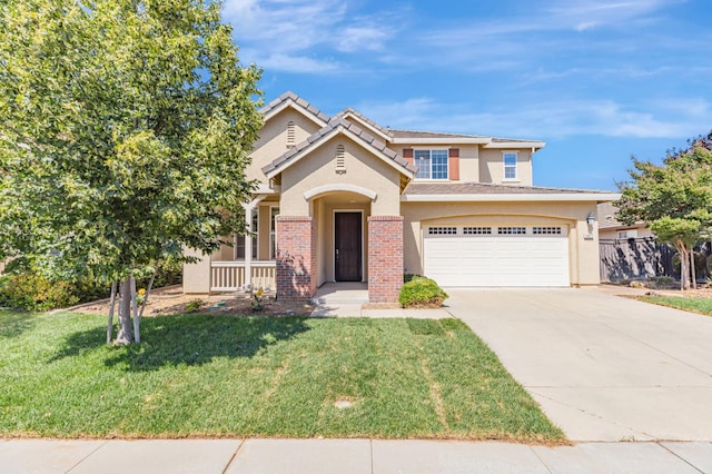 9877 Bluefin Way, Elk Grove, CA 95757 - view of front facade with stucco siding, concrete driveway, covered porch, a tiled roof, and brick siding
