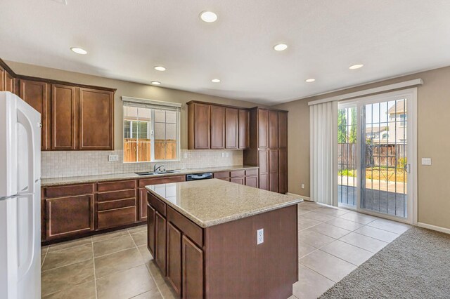 9877 Bluefin Way, Elk Grove, CA 95757 - kitchen with freestanding refrigerator, recessed lighting, decorative backsplash, a center island, and light tile patterned floors