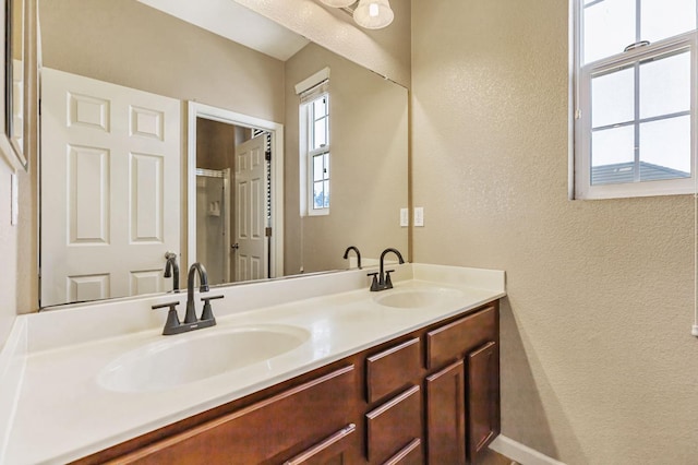 9877 Bluefin Way, Elk Grove, CA 95757 - bathroom featuring a textured wall and double vanity