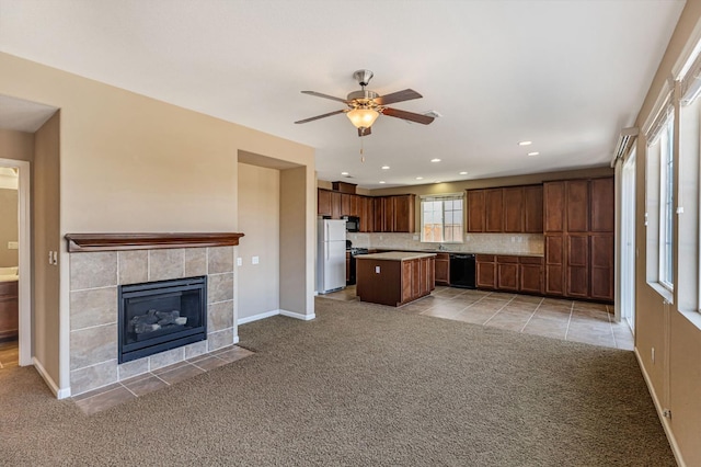 9877 Bluefin Way, Elk Grove, CA 95757 - kitchen featuring open floor plan, black appliances, light colored carpet, a center island, and a ceiling fan