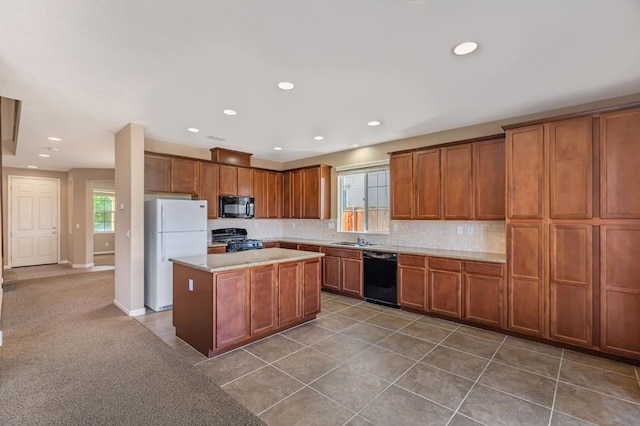 9877 Bluefin Way, Elk Grove, CA 95757 - kitchen featuring black appliances, decorative backsplash, recessed lighting, brown cabinets, and a kitchen island