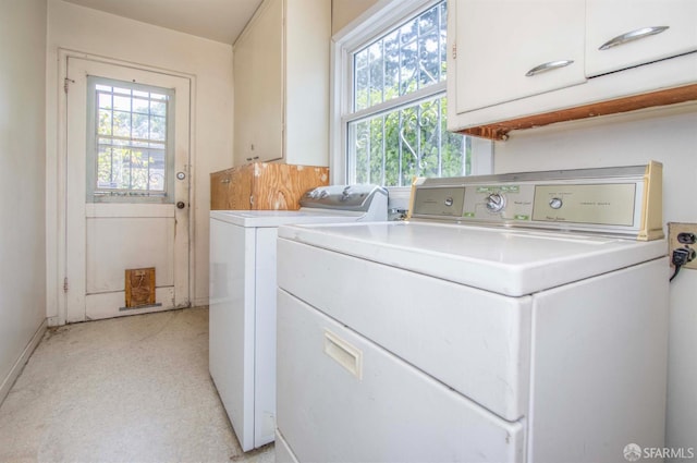 7520 Sunkist Dr, Oakland, CA 94605 - laundry area with cabinet space, washing machine and clothes dryer, and plenty of natural light