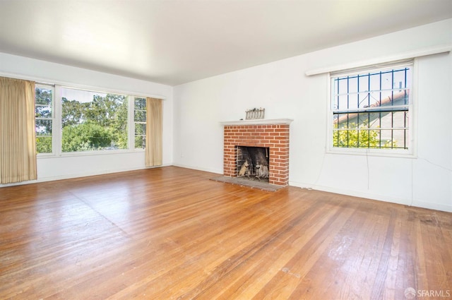 7520 Sunkist Dr, Oakland, CA 94605 - unfurnished living room with wood finished floors, healthy amount of natural light, and a fireplace
