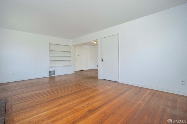 7520 Sunkist Dr, Oakland, CA 94605 - empty room featuring built in features and wood finished floors