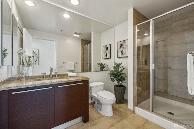 bathroom featuring vanity, recessed lighting, a shower stall, tile patterned floors, and toilet