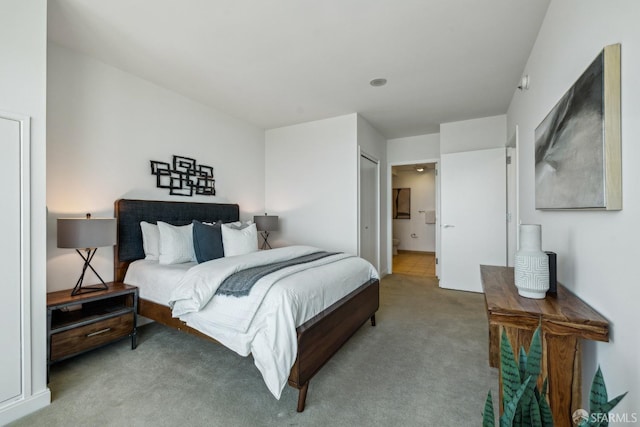 carpeted bedroom with connected bathroom