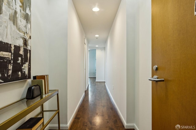 hall featuring recessed lighting, baseboards, and wood finished floors