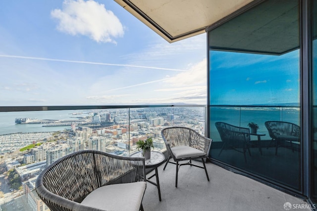 balcony with a view of city and a water view