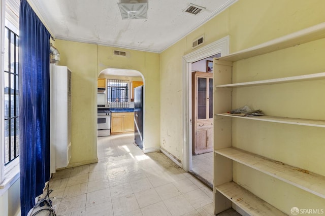 hall featuring ornamental molding and a textured ceiling