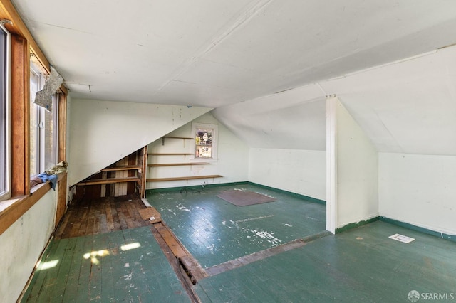 bonus room featuring vaulted ceiling and dark hardwood / wood-style flooring