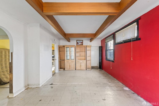 spare room with beam ceiling