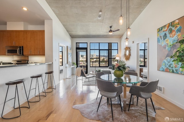 dining area featuring ceiling fan and light hardwood / wood-style flooring