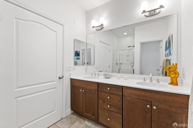 bathroom featuring walk in shower, vanity, and tile patterned flooring