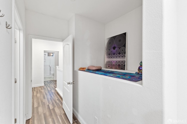 hallway with hardwood / wood-style flooring