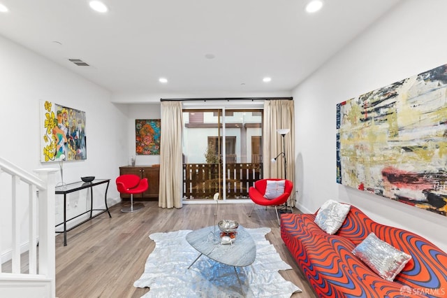 living room featuring a wealth of natural light and light hardwood / wood-style flooring