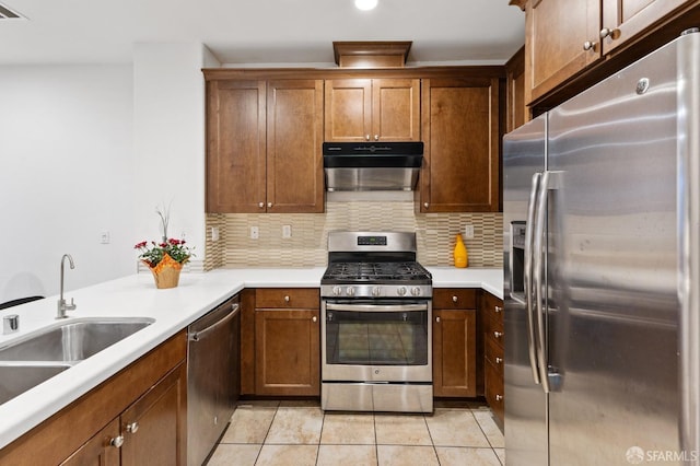 kitchen featuring light tile patterned floors, sink, appliances with stainless steel finishes, and tasteful backsplash