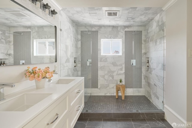 bathroom with visible vents, a stall shower, and a sink