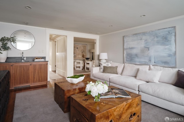 living room with wood finished floors and crown molding